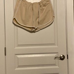 Stretchy beige shorts with a white drawstring